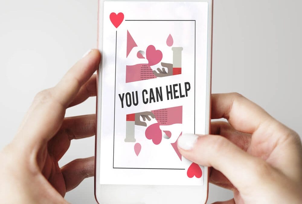 An iPhone screen showing a nonprofit landing page that says, “You Can Help”